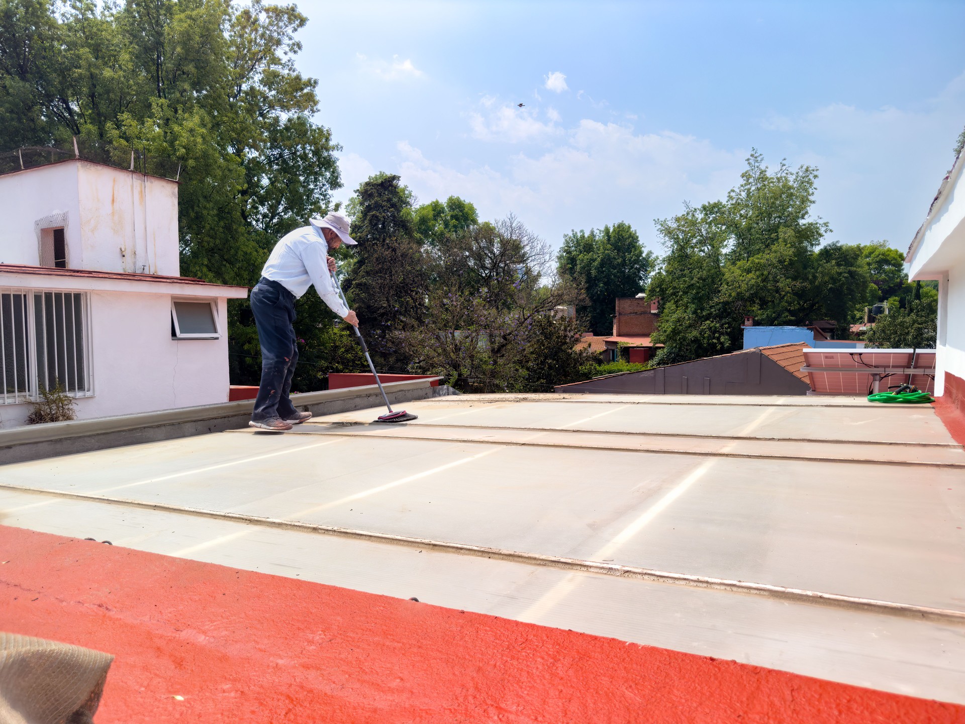 Man repairing and cleaning polycarbonate rooftop